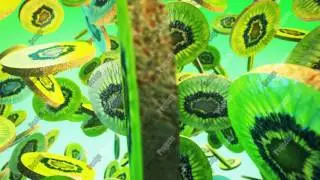 Falling fresh kiwi on green background. Close up. 4K