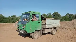 IFA Multikar 25 loading river sand with an Amkador.