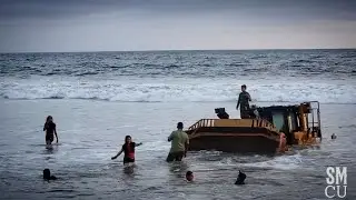 Kids Play on Sinking Bulldozer at Beach