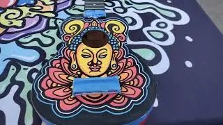 Painting Buddha Ukulele in the park.