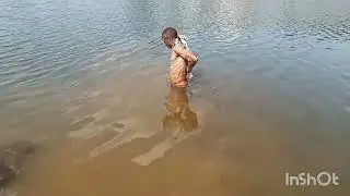 African boy taking bath in the river 