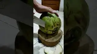 peeling young coconut