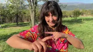 Tsetsi Trimming Branches in her Yard and Taking Care of the Garden of her Bulgarian Homestead
