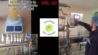 Máquina dosificadora por desbordamiento variable para el llenado de botellas de aceite de palma