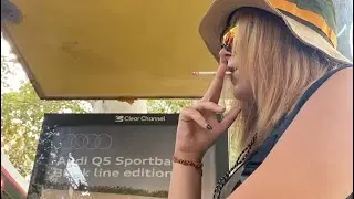 girl smoking at bus stop and flick  her cigarette