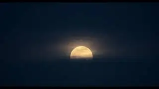 2021 Full Moon (Wolf Moon) over the pink ocean
