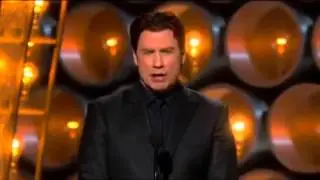 John Travolta presenting at the 86th Oscars