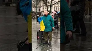 Grandfather is singing carols. Lviv near the Christmas tree.