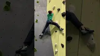 Kid rock climbing a route at the indoor climbing gym