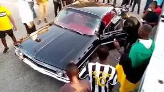 Fans M0b Sulley Muntari as He Pulls Up1967 Chevrolet Impala SS at Accra Sports Stadium