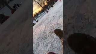 Watch out! Sledding down icy hill.