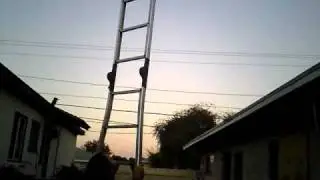 caleb balences a 12 foot ladder