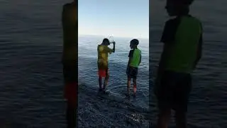 2 boys swimming in a cold lake