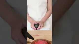 Woman Peeling And Pitting An Avocado 