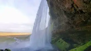 Walking behind Seljalandsfoss waterfall and around nearby falls in Iceland
