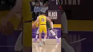 Austin Reaves crosses over Giannis Antetokounmpo