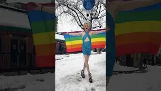 Gay Model Anastasia Harris Waves The Rainbow Flag in the Snow