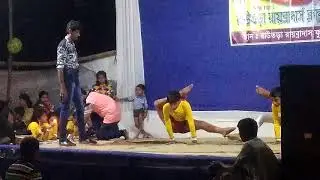 Little boys are performing awesome yoga in stage in durgapuja festival