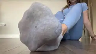 Gym girl takes off her smelly socks after workout