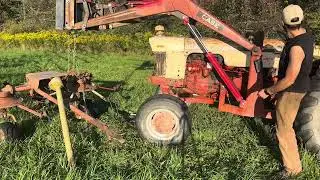 Moving hay and fixing a flat on the Tedder