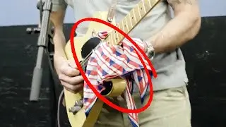 Why is he playing guitar with a CLOTH?