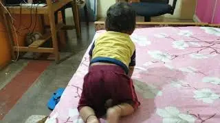 Baby climbing down the bed