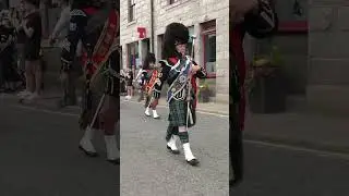 Mace flourish by Drum Major Barclay leading pipe bands after 2023 Ballater Highland Games 