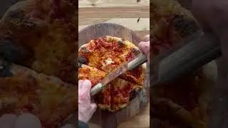 Slicing a homemade cheese pizza