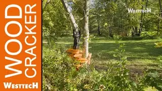PM-Trac mit einer kardanischen Greifersäge, Woodcracker® CS510 crane