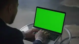 Asian businessman working on green screen laptop