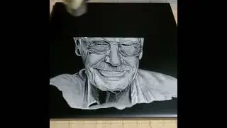 Laser photo engraving on white tile painted black