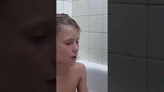 Kiddo blowing bubbles in the bathtub