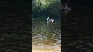 Двоє пливуть під паросолькою