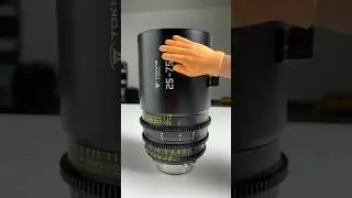 Huge camera lens or tiny hand 