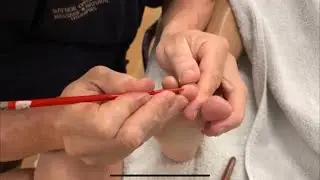 Deep foot reflexology massage. Raynor foot massage using massage tools.