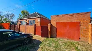 What kind of house with a large plot of land can I buy in a village in the south near Krasnodar?