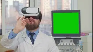 bearded doctor wearing 3d vr glasses computer with green screen on the back