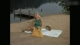 Drowning blonde female swimmer by scuba diver