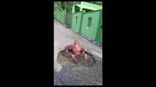 MAN TAKES A BATH IN THE ROAD