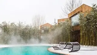 Elevation Workshop positions wooden cabins around the edge of a hot spring in Beijing