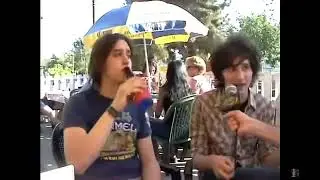 julian casablancas downing a shot with a beer and lighting a cigarette