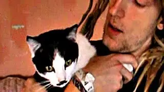 Dreadlocked man sings to his mustached cat (Father and Cat)