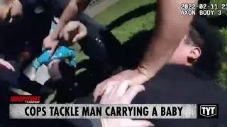 Cops Tackle Man Carrying A Baby