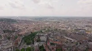 Aerial view of Brussels, revealing a vast urban landscape with traditional architecture, green