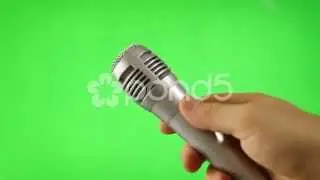 Stock footage of holding microphone isolated green screen