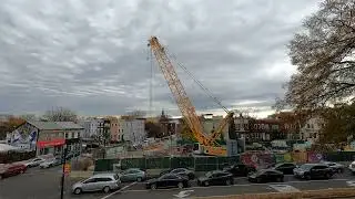 80 ton crane lowers 2 cement mixers into construction pit