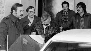 John Wayne Gacy escorted in unmarked police car (December 23, 1978)