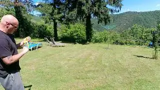 Slingshot shooting. Flat top Hai-Style, jar lid on the ground.