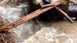 Pedestrian bridge over Kilmer Creek damaged by heavy water flow. District of North Vancouver.