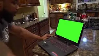 Man punches computer green screen